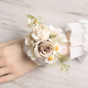 Detailed view of elegant artificial floral wrist corsage with champagne roses and lace.