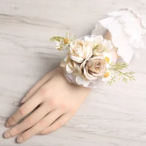 Detailed shot of artificial wrist flower with lace and roses for wedding party decor.