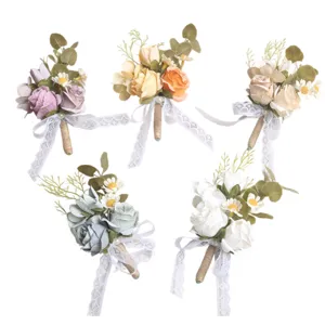 Set of five colorful artificial flower boutonnieres with lace ribbons for weddings.