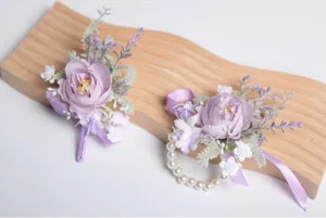 Purple artificial flower boutonniere and wrist corsage set with pearls for wedding party decor.
