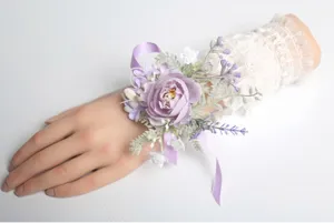 Purple artificial flower wrist corsage detail, elegant wedding party floral accessory.
