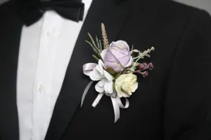 Artificial wedding rose corsage boutonniere for groom suit tuxedo, elegant floral wedding decor.