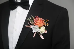 Detailed close-up shot of artificial rose wedding groom boutonniere with floral details.