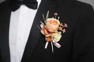 Elegant rose boutonniere detail for wedding groom and groomsmen suit decoration closeup
