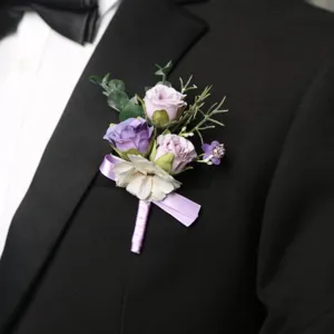 Elegant purple artificial flower wedding boutonniere for groom and wedding guests accessory.