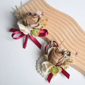 Elegant wedding artificial rose boutonniere and wrist flower set for bride and groom ceremony.
