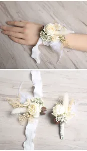 Detail view of handmade wedding wrist corsage and boutonniere with white floral decor.