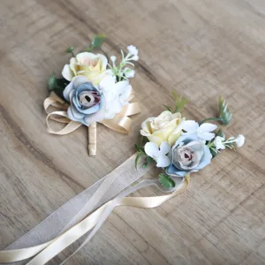Artificial rose wrist flower and boutonniere set, perfect for rustic outdoor wedding decor.