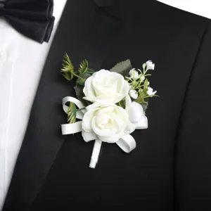 Elegant artificial white rose boutonniere for wedding groom, corsage brooch with ribbon.