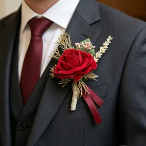 Red artificial rose boutonniere with ribbon for wedding groom suit tuxedo accessory.