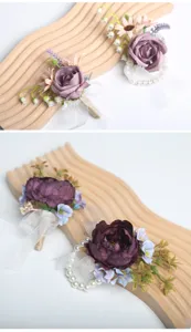 Detailed view of purple artificial flower boutonnieres and wrist corsages with pearls and ribbon.