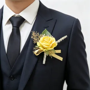 Close-up detail of a yellow artificial rose boutonnière with green leaves for wedding suits.