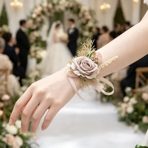 Close-up detail of wedding wrist corsage with pink artificial rose, ribbon and wheat accents.