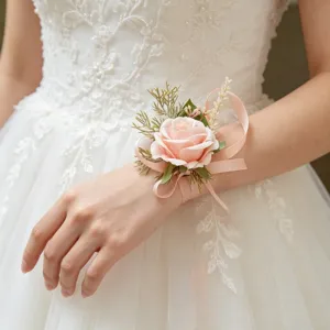 Pink artificial rose wrist corsage detail, elegant floral wedding accessory with ribbon.