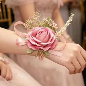 Pink rose wrist corsage for wedding bridesmaids, elegant artificial floral bracelet accessory.