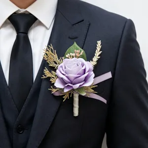 Detailed view of a purple artificial rose boutonniere with dried grass for wedding suits.