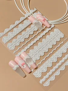 White lace nail art stickers featuring delicate embossed French style designs for elegant manicure.
