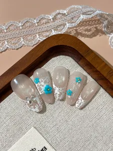 Handmade press-on false nails featuring vintage lace, cat eye glitter, and floral art details