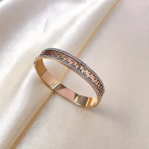 Rose gold titanium steel rhinestone bangle with classic geometric greek key pattern luxury jewelry.