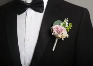 Exquisite artificial wedding boutonniere detail shot for groom and groomsmen floral decor.