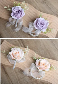 Artificial rose wrist corsage set with pearls and ribbons for wedding party decor.