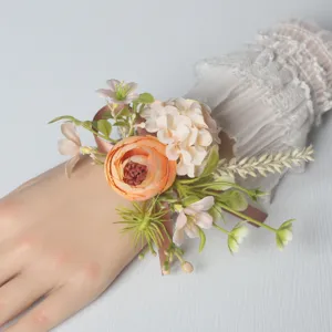 Close-up detail view of the artificial floral wrist corsage with ribbon for wedding party.
