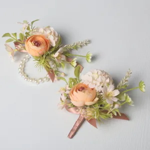 Artificial wedding corsage and wrist flower set with pearls and ribbons, ideal for bride and groom.
