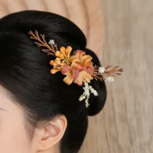 Close-up detail of forest style artificial floral hair clip, vintage rustic hair accessory.