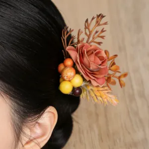Detailed shot of forest style floral hair pin with artificial rose and berries for updos.