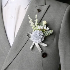 Elegant wedding boutonniere groom corsage with grey flower and white ribbon for business meetings.