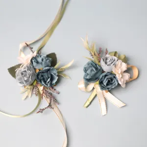 Dusty blue wedding corsage and wrist flower set with ribbons for groom bride and guests.