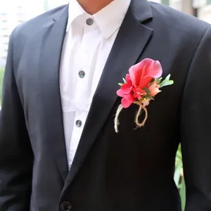 Elegant wedding boutonniere featuring pink calla lily and twine, perfect for groom and groomsmen.