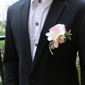 Close-up detail of wedding groom calla lily boutonniere with natural burlap twine wrap.