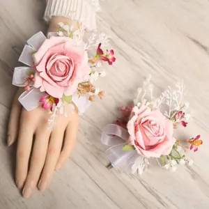 Pink artificial rose wrist corsage set for wedding party, elegant floral design detail.