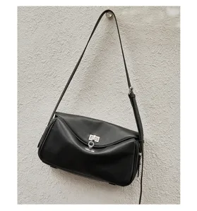 Detailed shot of black genuine leather shoulder bag with metal lock, versatile and chic.