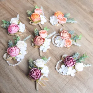 Handmade artificial rose boutonniere and wrist corsage set for wedding party decor.