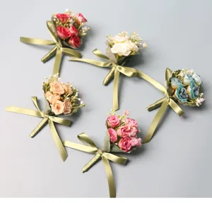 Artificial rose corsage boutonniere with green ribbon for wedding groom groomsmen guests.