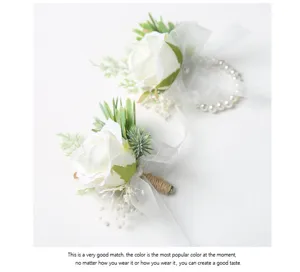 Detailed view of white artificial rose wedding boutonniere and pearl wrist corsage set.