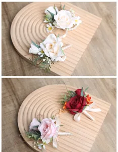 Close-up details of artificial rose boutonnieres with green leaves and ribbon for wedding.
