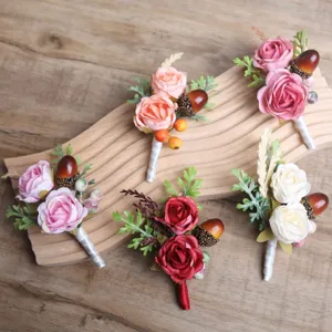 Rustic artificial rose boutonnieres set with pine cones and berries for wedding groomsmen suits.