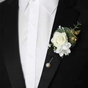 Elegant forest style wedding boutonniere with white rose green leaves and pearl pin.