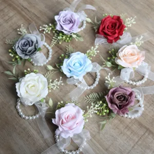 Artificial rose wrist corsage set with pearls and ribbons for wedding party prom decor.