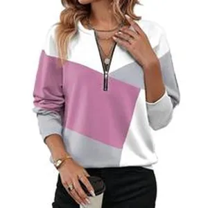 Close-up detail van casual dames kleurenblok top met lange mouwen en halve rits.
