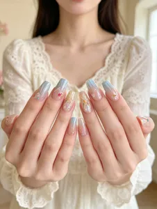 Detailed close-up of glossy gradient press-on nails featuring 3D pearls and floral art.