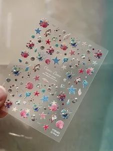 Summer ocean theme embossed nail stickers detail shot featuring cute starfish and shell designs.