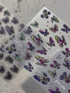 Close-up detail of holographic 3D butterfly nail art stickers with embossed stars sheet.