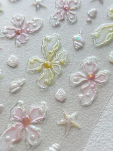 Closeup detail of translucent pearlescent 3D flower shell nail art stickers for stunning manicure.