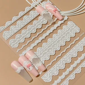 White lace nail art stickers with elegant French style floral patterns and cute bow designs.