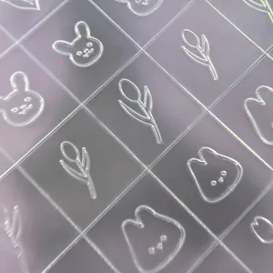 Transparent embossed nail art sticker sheet with cute cartoon rabbit and tulip minimalist designs.