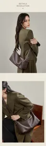 Detailed view of the brown genuine leather underarm bag showcasing its fine texture and zipper.